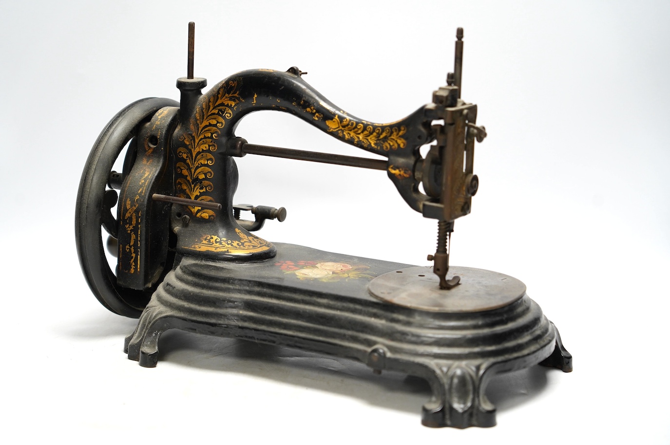 A late 19th century Bradbury & Co Wellington sewing machine on a cast iron base with gilt and floral decoration. Condition - fair